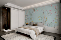 Chinoiserie wall mural with white trees and pink roses in a guest bedroom.