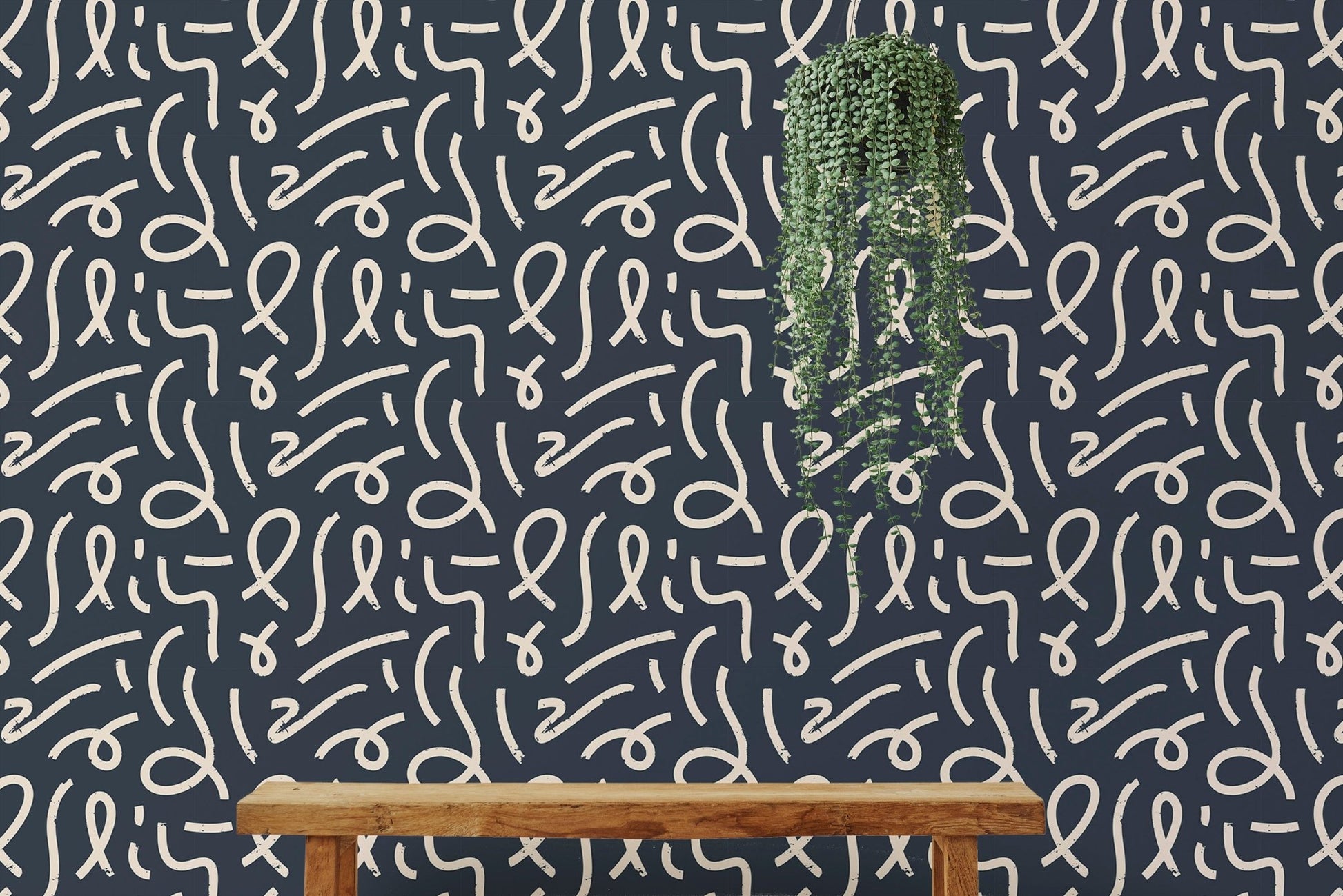 Black and white brush stroke wallpaper in a minimalist room with a wooden bench.