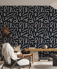 Abstract squiggle wallpaper in a home office setting with a seated person.
