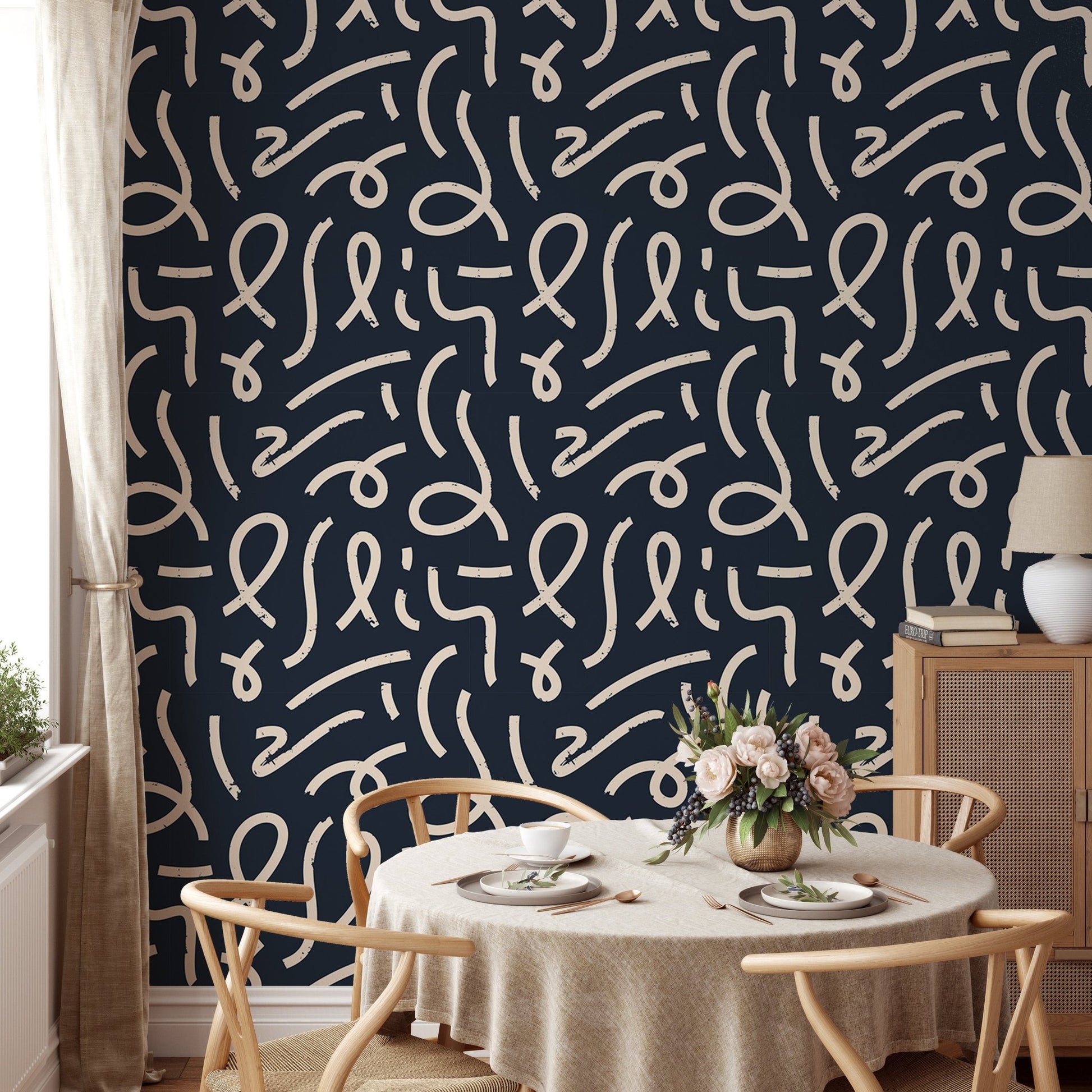 Black wallpaper with white lines in a dining room with a round table.
