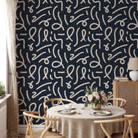 Black wallpaper with white lines in a dining room with a round table.