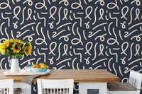 Minimalist abstract line art wallpaper in a dining area with a wooden table.