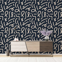 Minimalist brush stroke wallpaper behind a modern wooden sideboard.