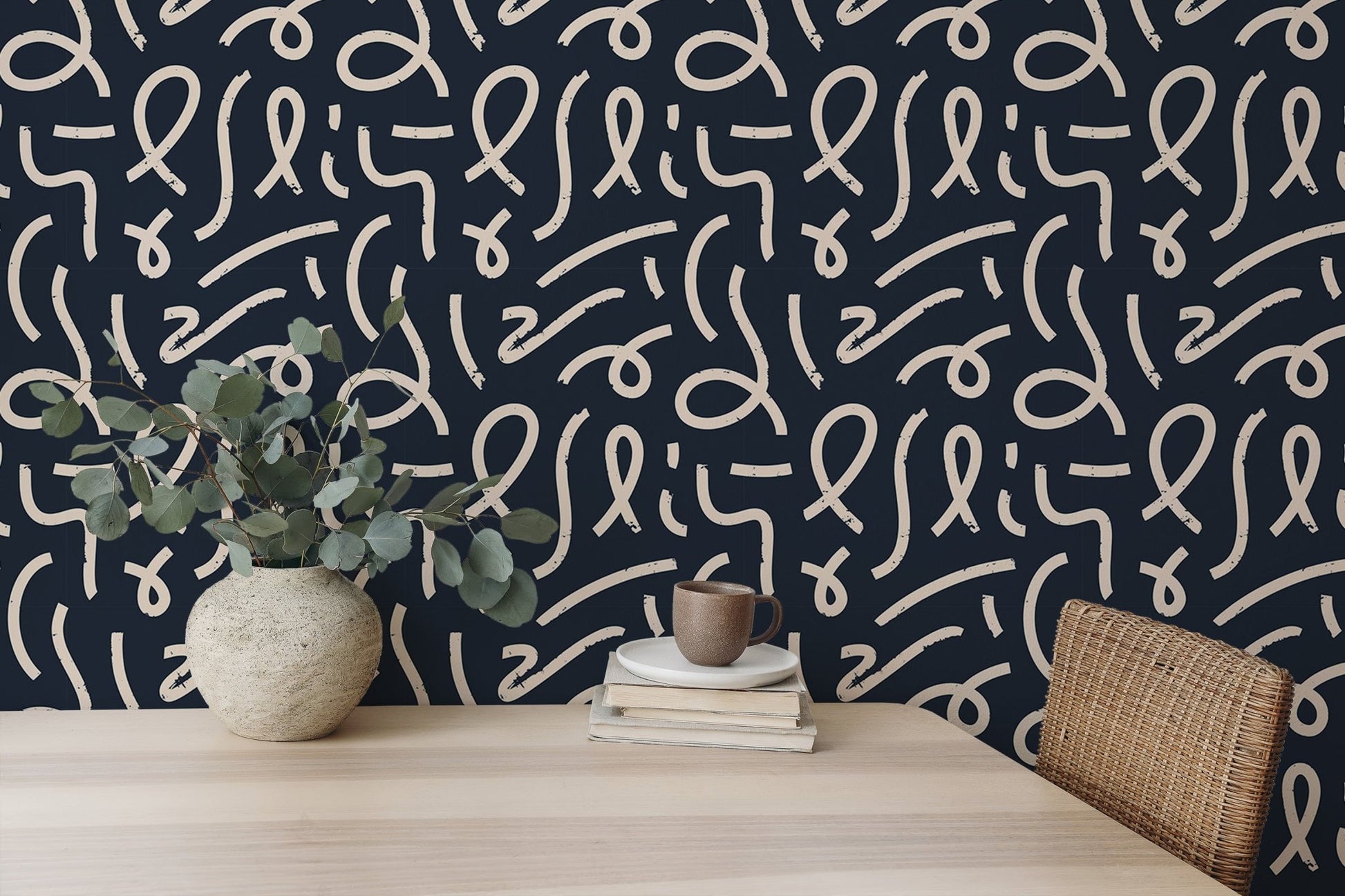 Abstract line wallpaper on a feature wall behind a wooden desk with a green plant.