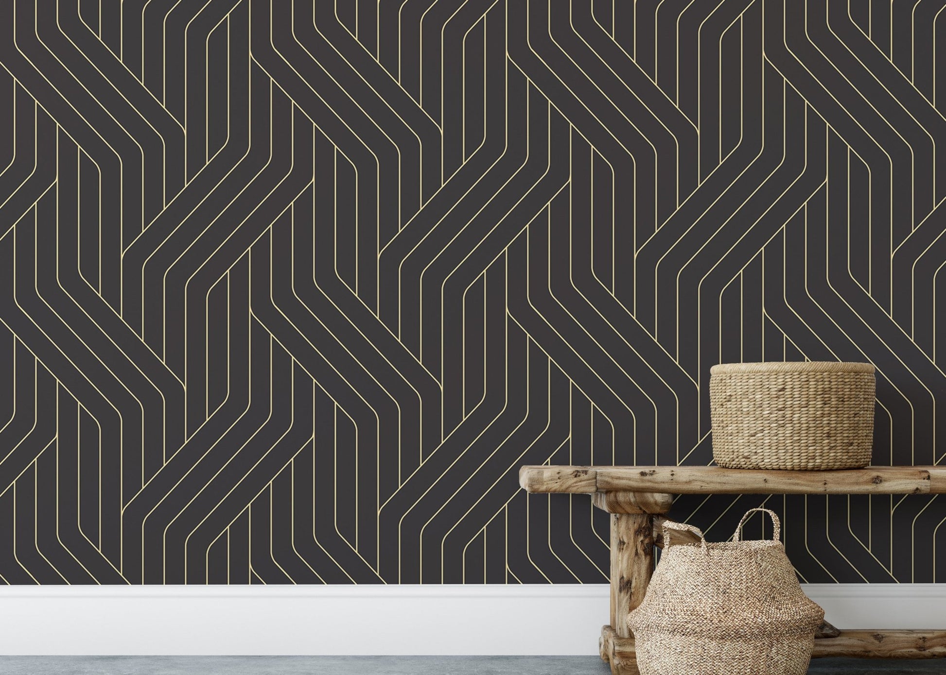 Rounded black and gold Deco line wallpaper behind wooden bench and basket.