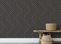 Rounded black and gold Deco line wallpaper behind wooden bench and basket.