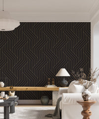 Modern black and gold ornate Deco patterns wallpaper in bright living space.