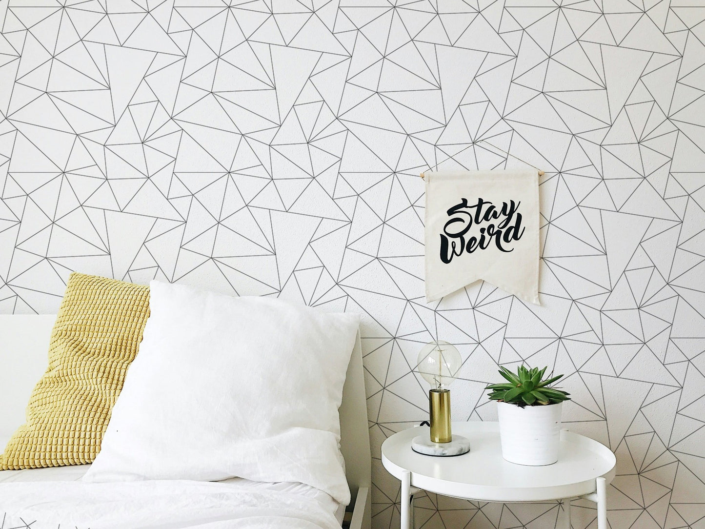 Bedside view showing a minimal black and white geometric wallpaper.