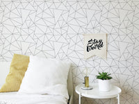 Bedside view showing a minimal black and white geometric wallpaper.