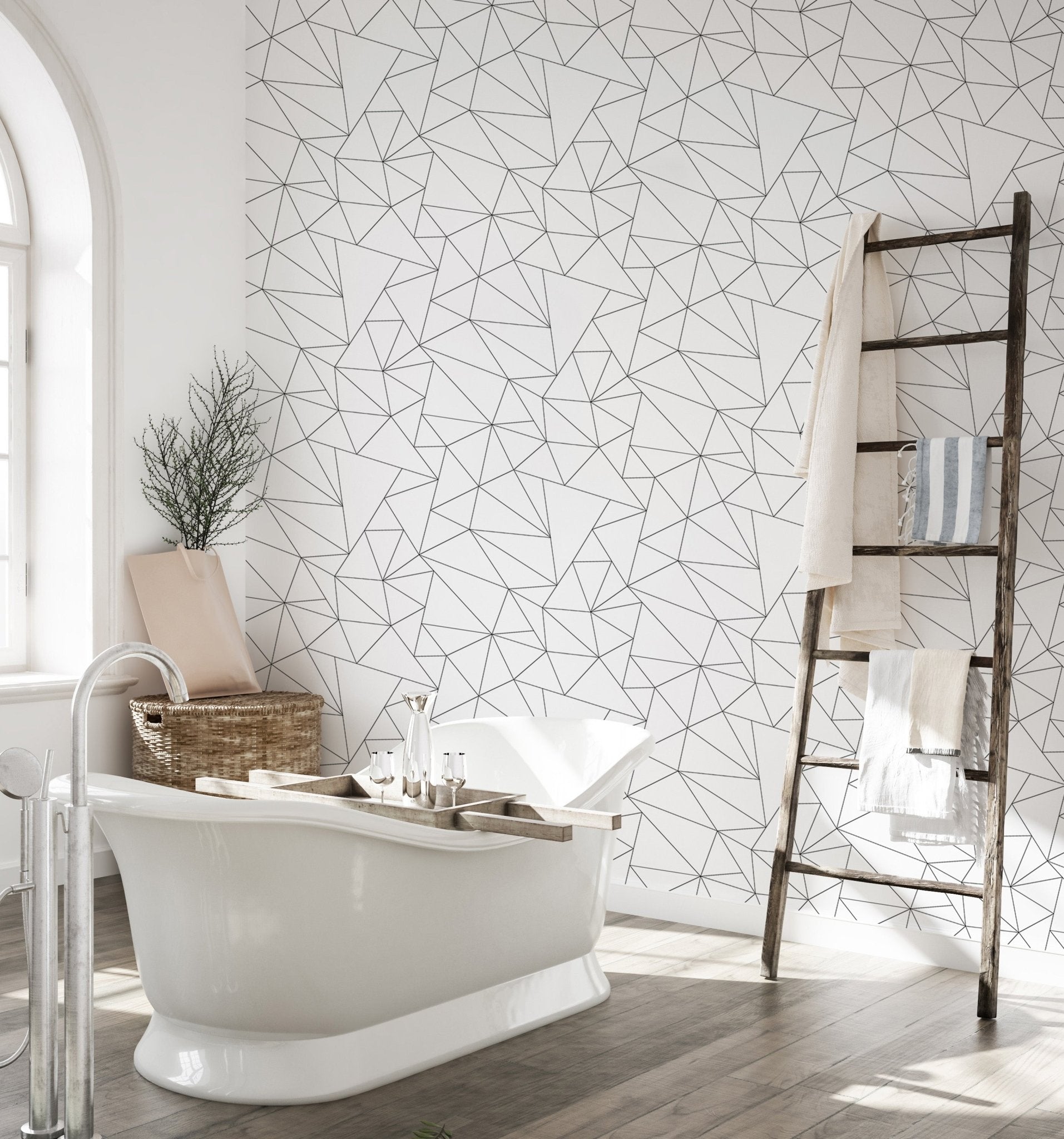 Large bath tub near black and white abstract geometric pattern wallpaper.