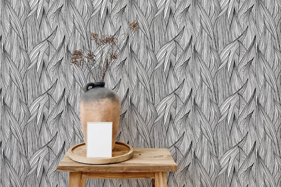 Abstract nature inspired wallpaper behind a wooden table with a large vase.