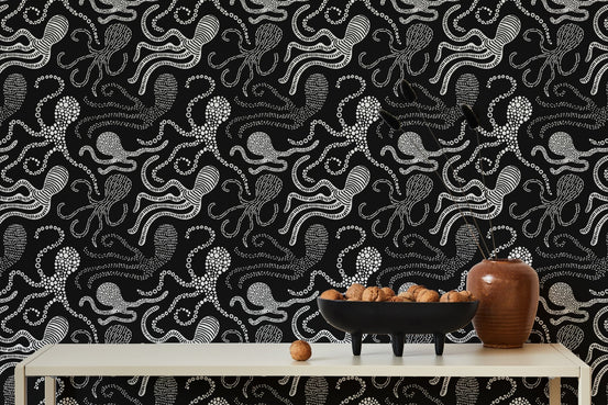 Black and white wallpaper with abstract octopus design behind dining table.