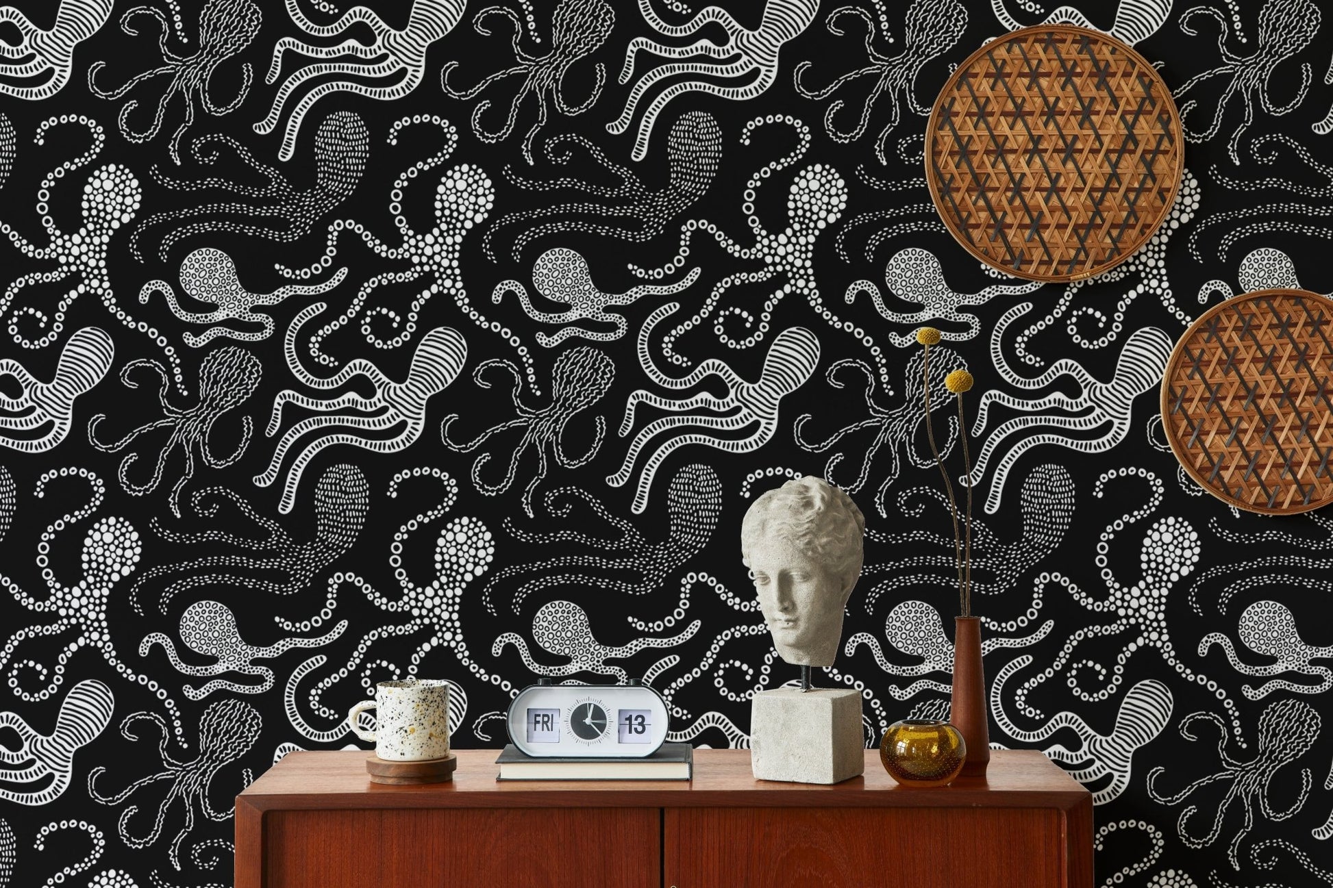 Black and white octopus wallpaper on a feature wall with mid-century furniture.