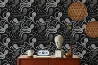 Black and white octopus wallpaper on a feature wall with mid-century furniture.