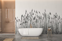 Tall grass canebrake wall mural in a bathroom behind a white freestanding bathtub.