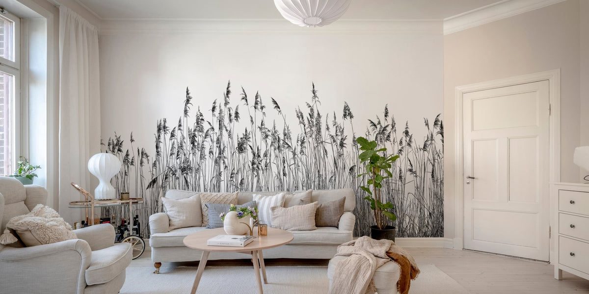 Black and white canebrake wall mural in a bright living room with cream sofa.