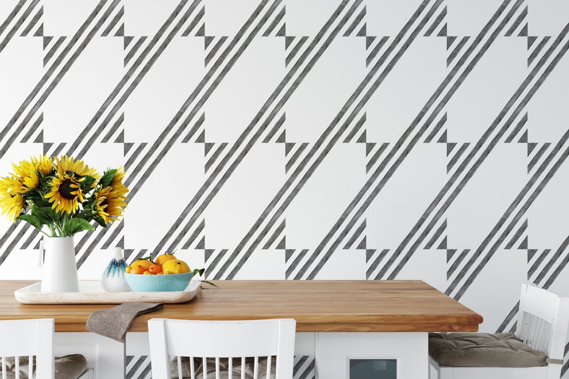 Kitchen table set against a black and white diagonal stripe wallpaper.