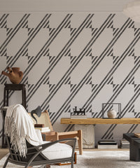 Interior lounge with a rocking chair and geometric stripe wallpaper design.