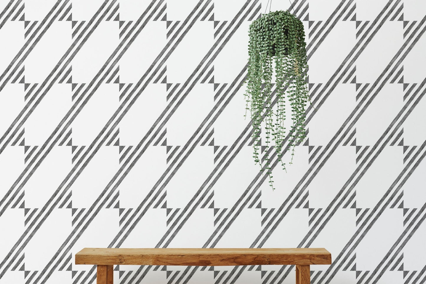 Wooden bench positioned in front of a diagonal stripe wallpaper background.