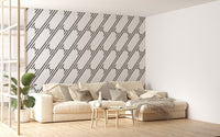 Large living space with a sofa and grey diagonal stripe wallpaper.
