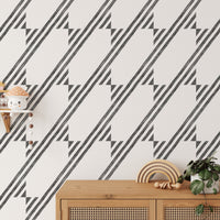 Wooden desk surface with a background of diagonal stripe wallpaper.