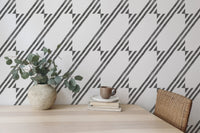 Dining area featuring a striped wallpaper and simple wooden furniture.