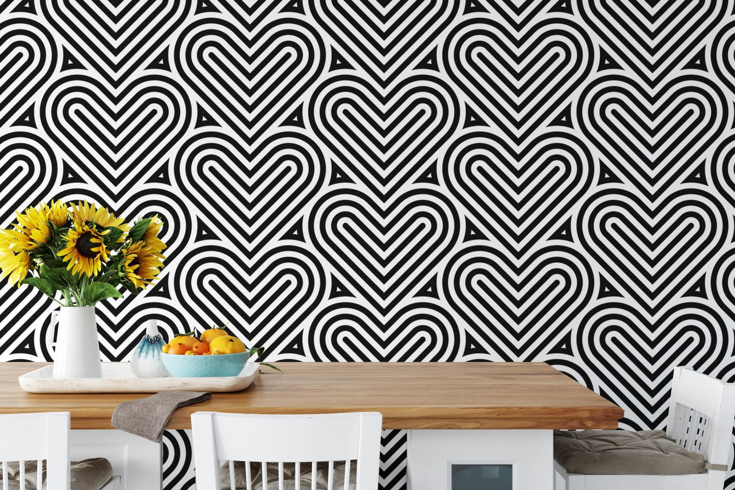 Geometric linear wallpaper in a dining area with a white table and sunflowers.