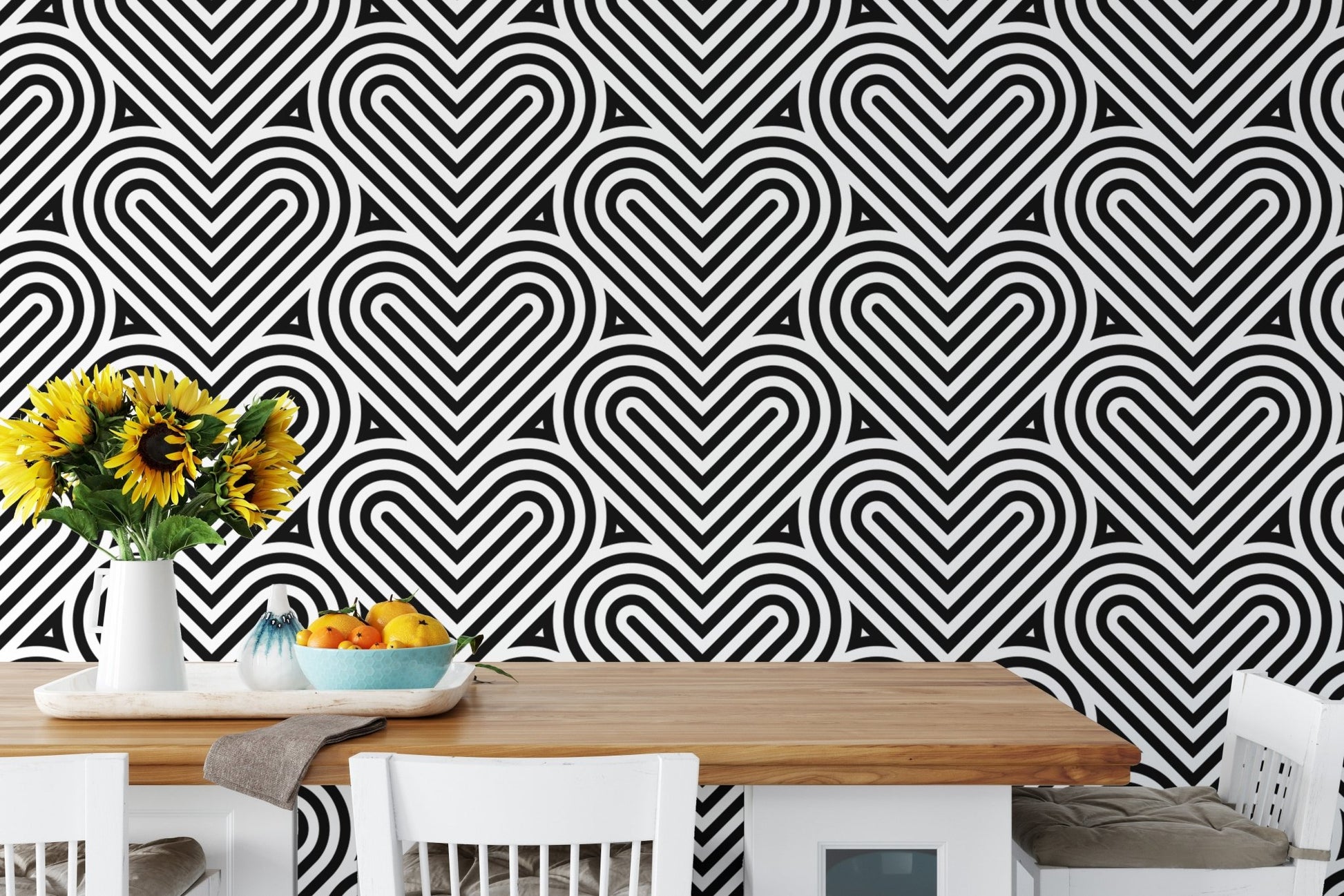 Geometric linear wallpaper in a dining area with a white table and sunflowers.