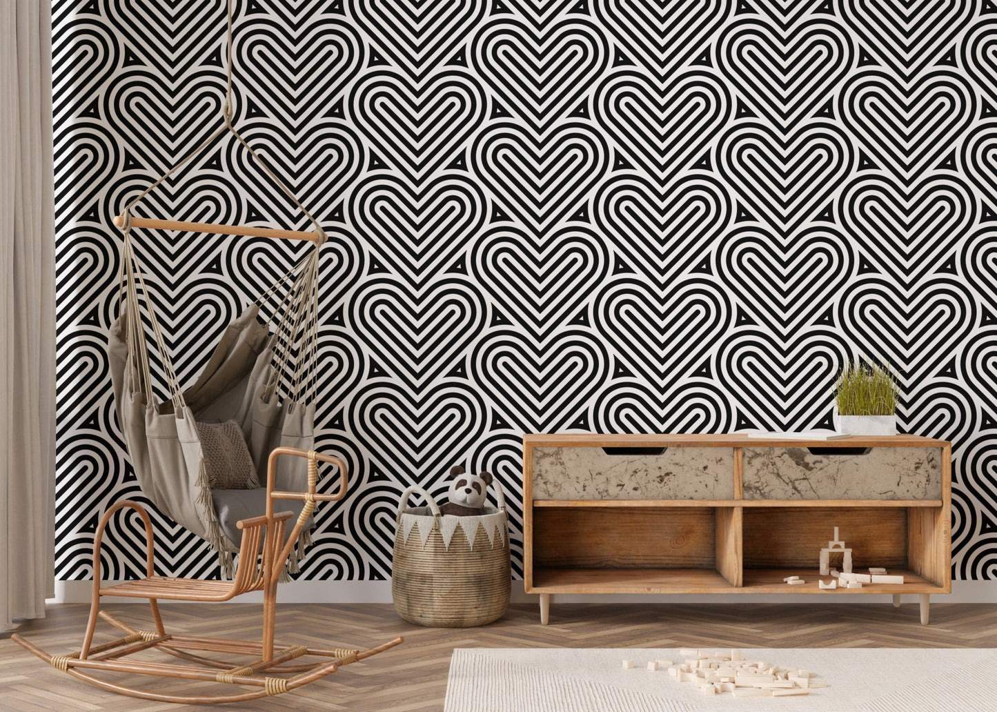 Linear heart wallpaper in a nursery area with a hanging chair and wood chest.