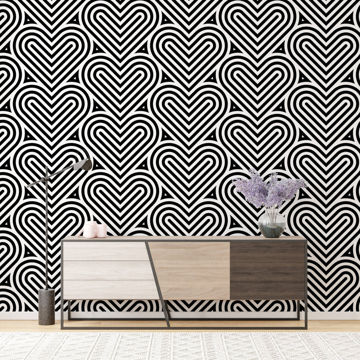 Geometric heart wallpaper behind a wooden sideboard with purple flowers.