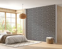 Monochrome geometric wallpaper in a bedroom with a white bed and large window.