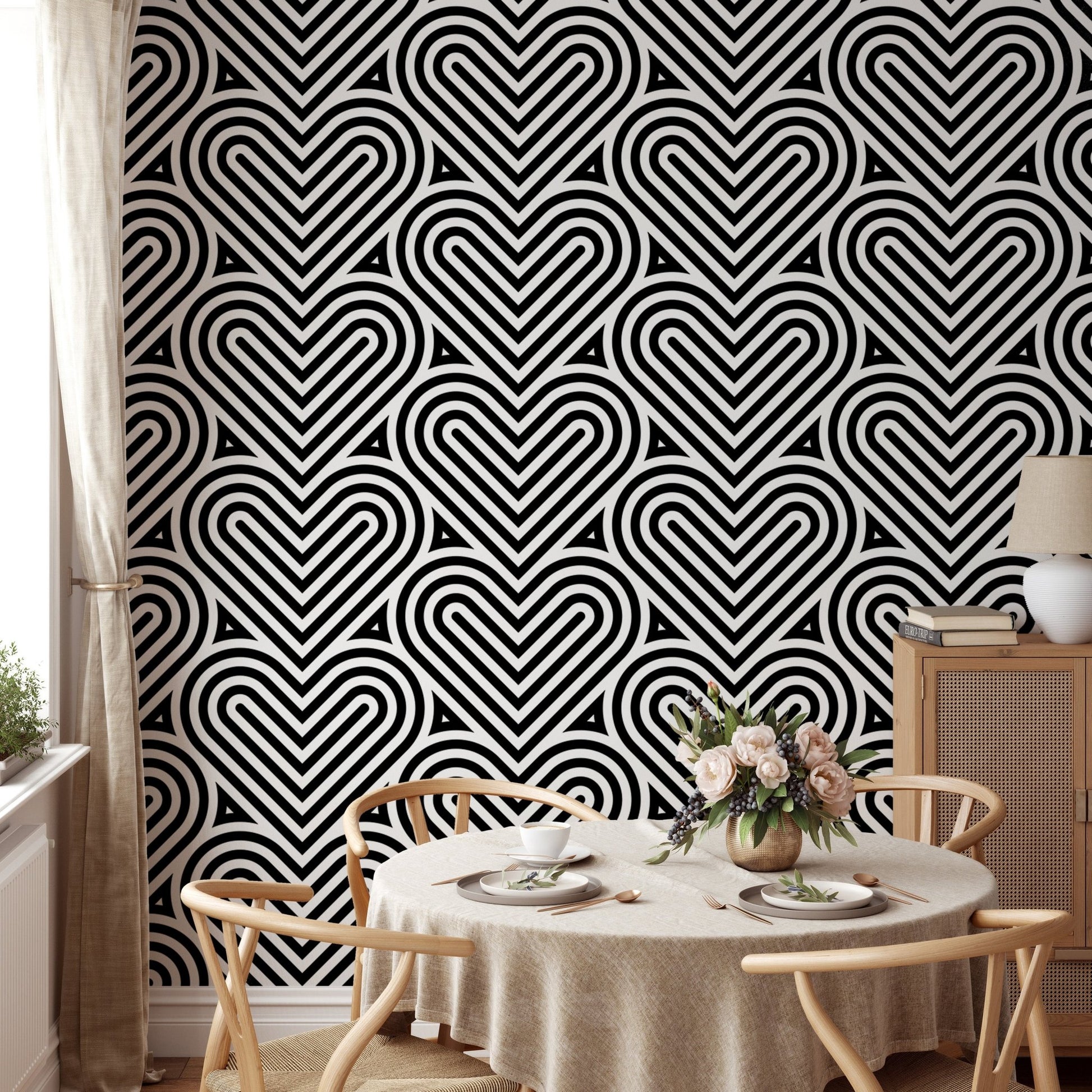 Repeating heart wallpaper in a dining room with a round wooden table.