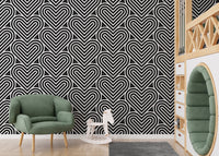 Heart pattern wallpaper in a playroom with a green chair and toy horse.
