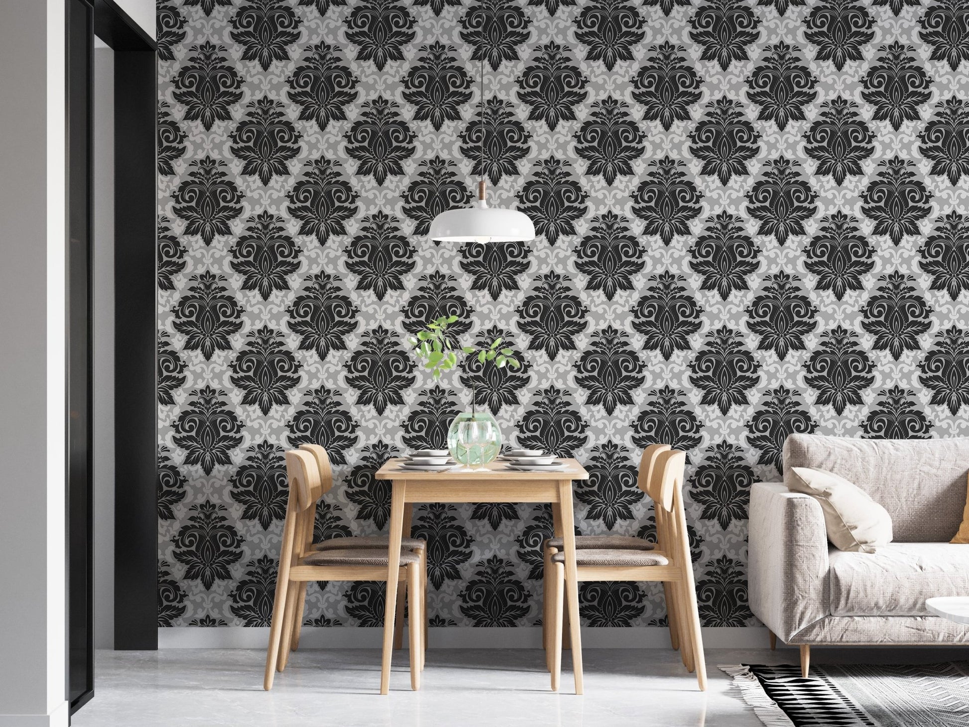 Classic damask pattern wallpaper in a minimalist dining area with light wood furniture.