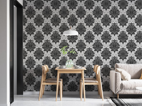 Classic damask pattern wallpaper in a minimalist dining area with light wood furniture.