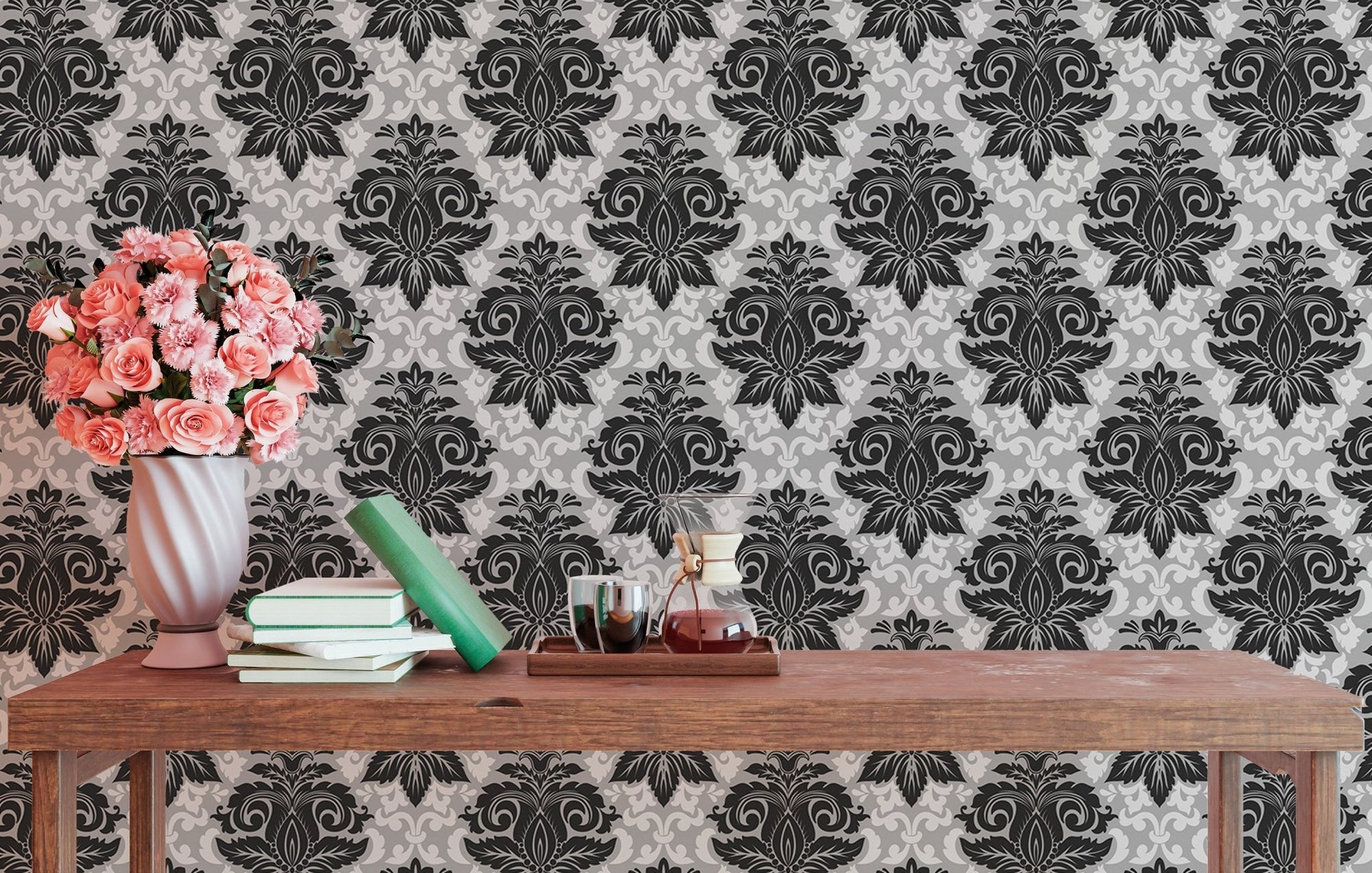 Black and white damask wallpaper on a living room wall with a wooden table.