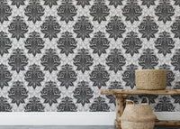 Symmetrical damask wallpaper on a feature wall above a low wooden bench.