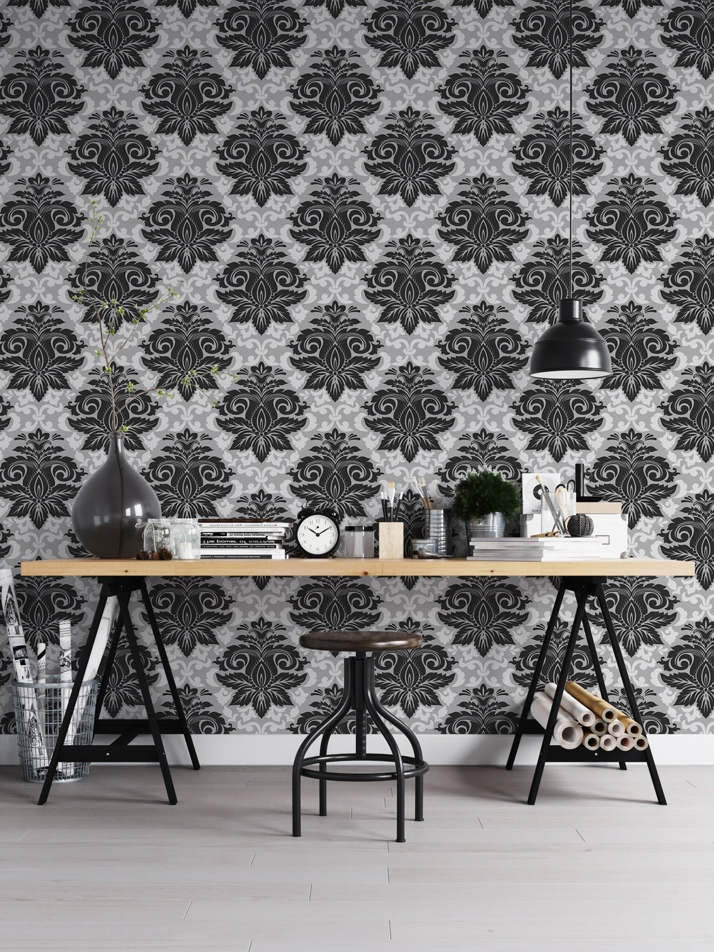 Monochrome damask wallpaper used as a backdrop for a home office desk.
