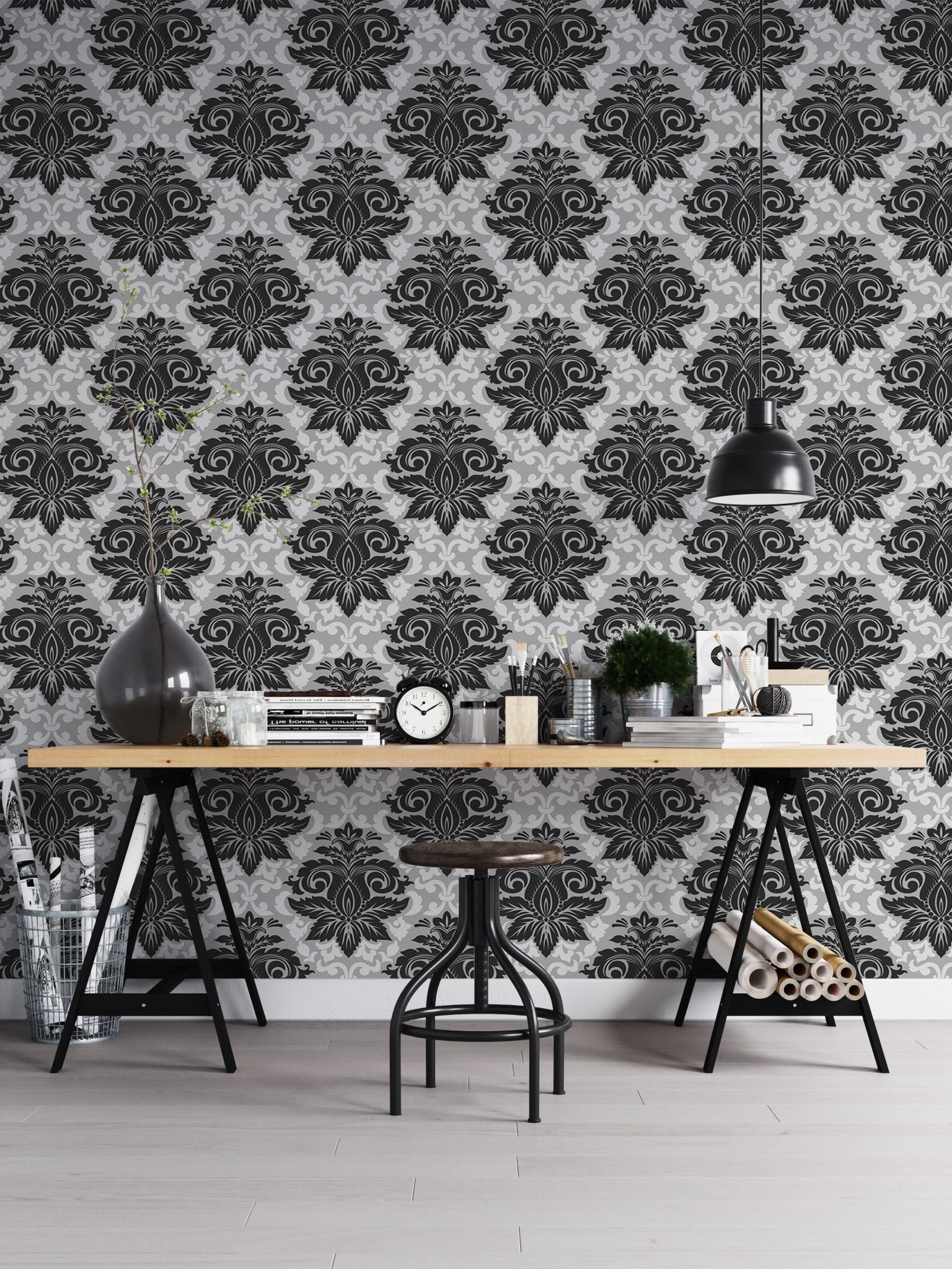 Monochrome damask wallpaper used as a backdrop for a home office desk.