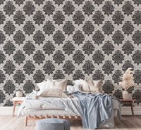Textured greyish damask wallpaper in a bedroom setting with blue bedding.
