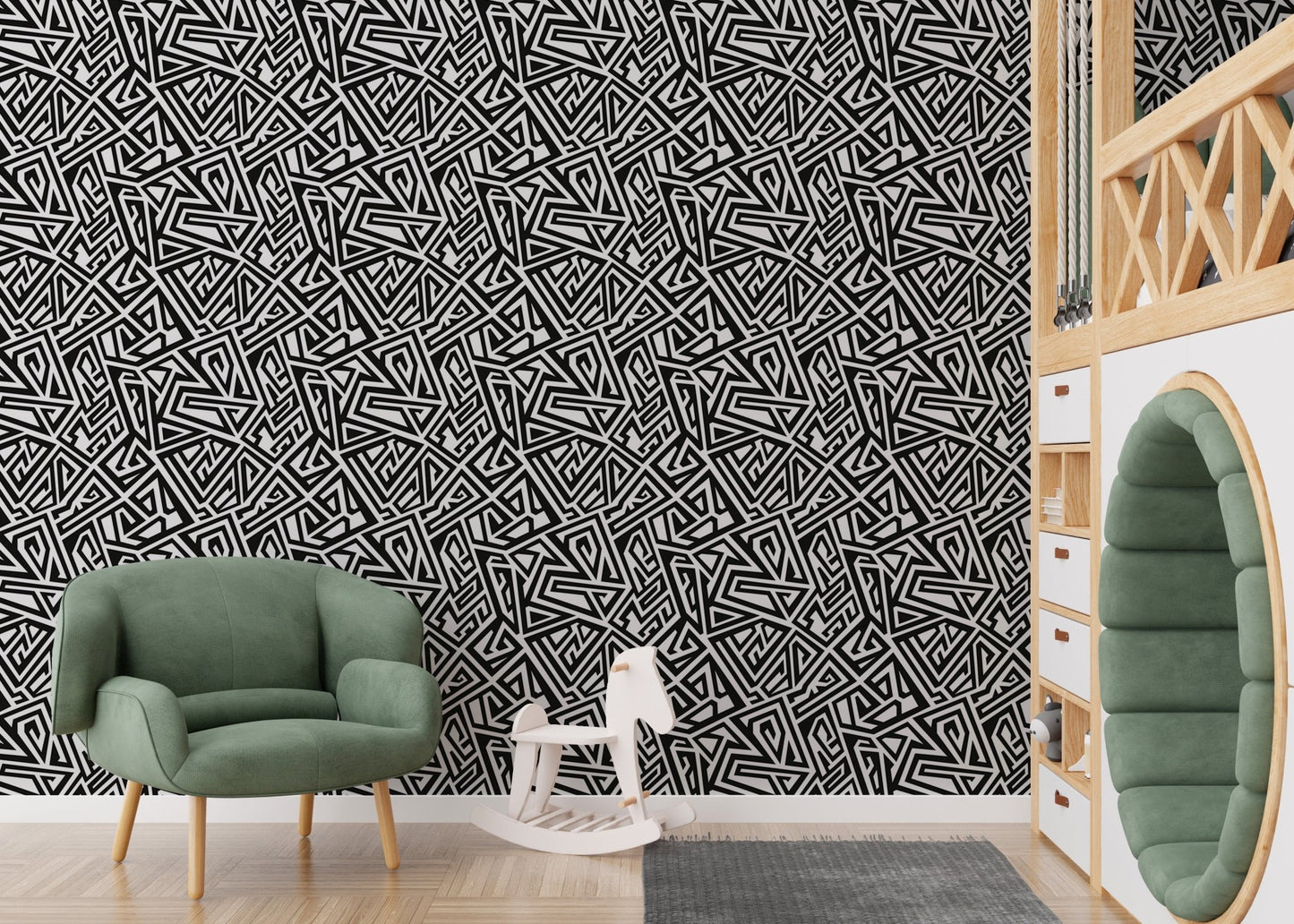 Monochrome ancient geometric wallpaper in a nursery with a green armchair.