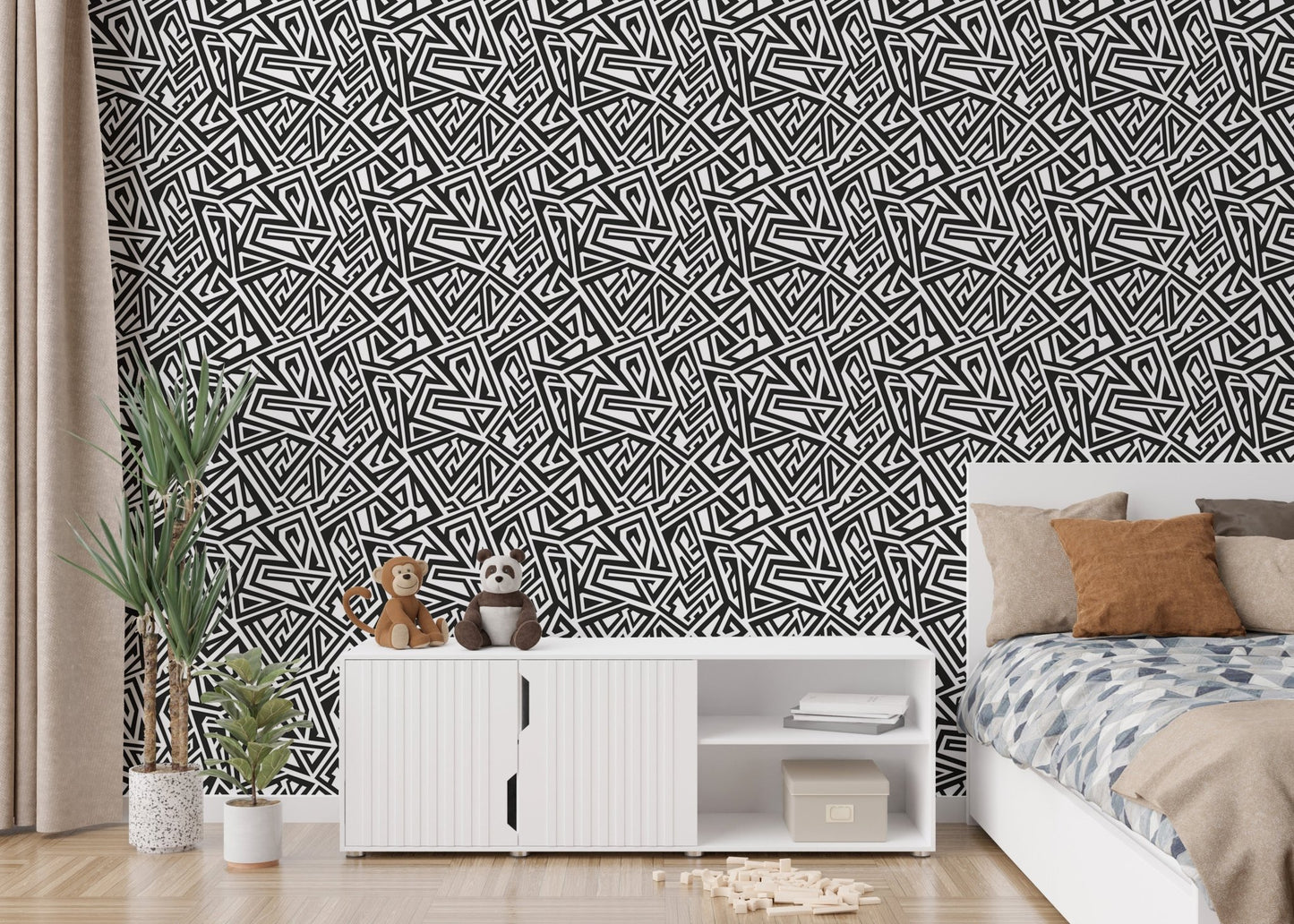 Bedroom wallpaper with geometric patterns next to a white dresser and plants.