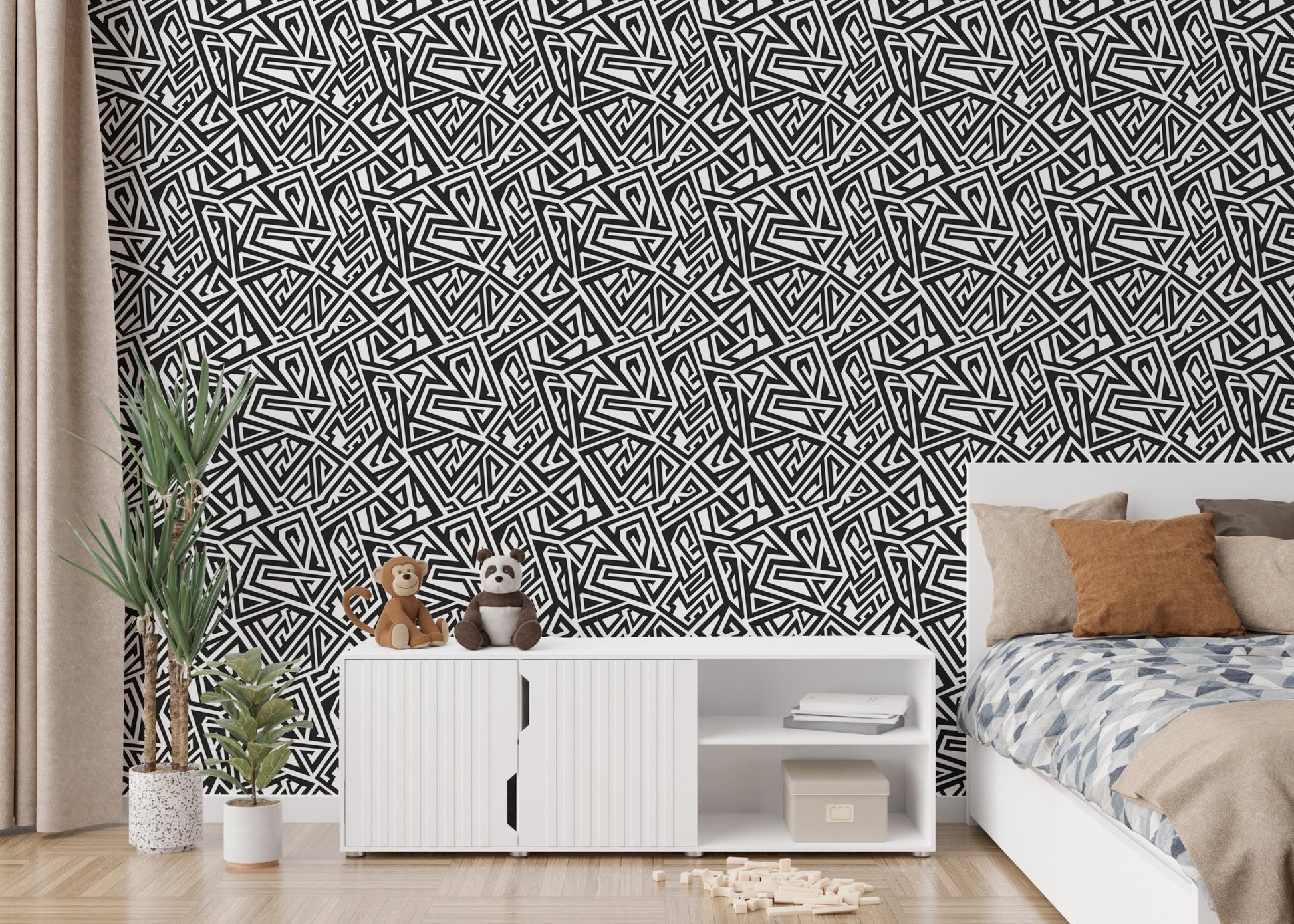 Bedroom wallpaper with geometric patterns next to a white dresser and plants.