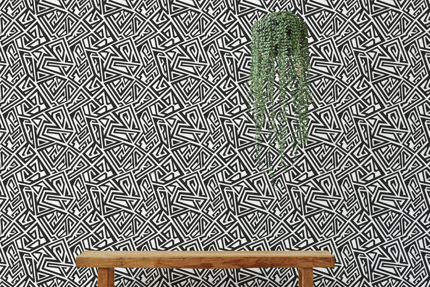 Living room accent wall with geometric wallpaper behind a wooden bench.