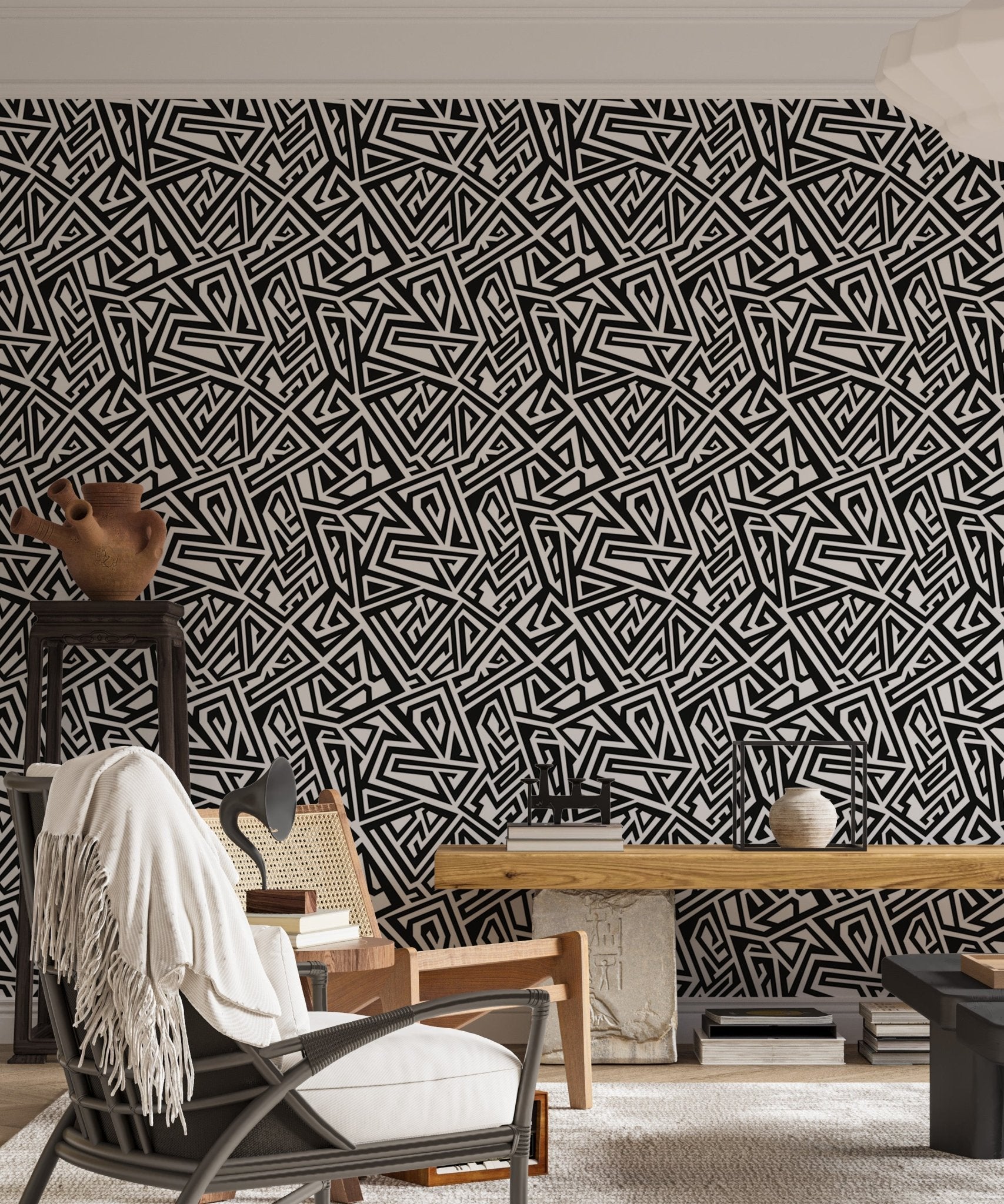 Detailed geometric wallpaper pattern in a home with a black chair.