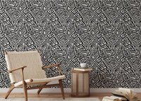 Minimalist reading area showing black and white ancient geometric wallpaper.