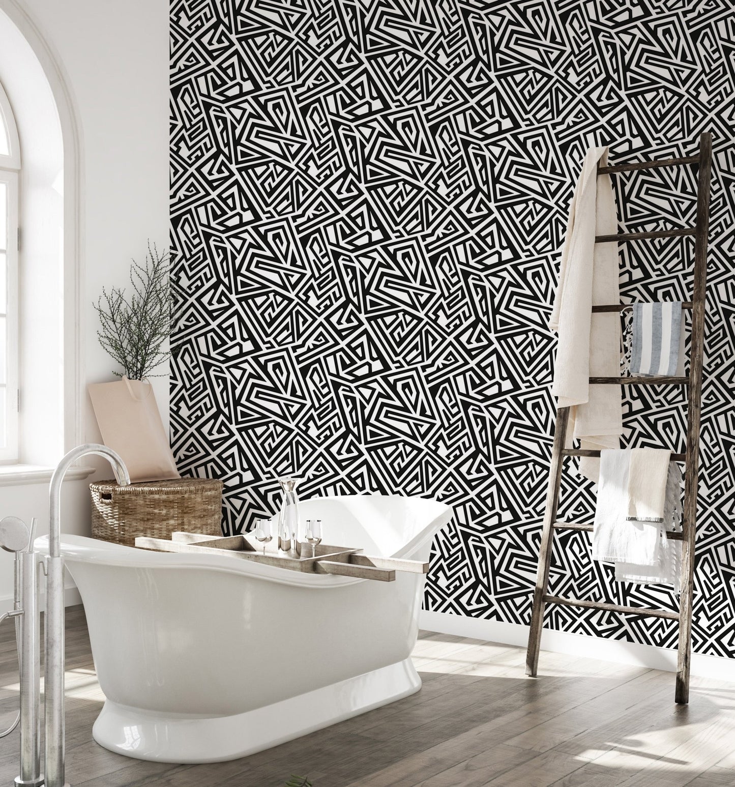 Bathroom interior featuring monochrome wallpaper behind a white freestanding tub.