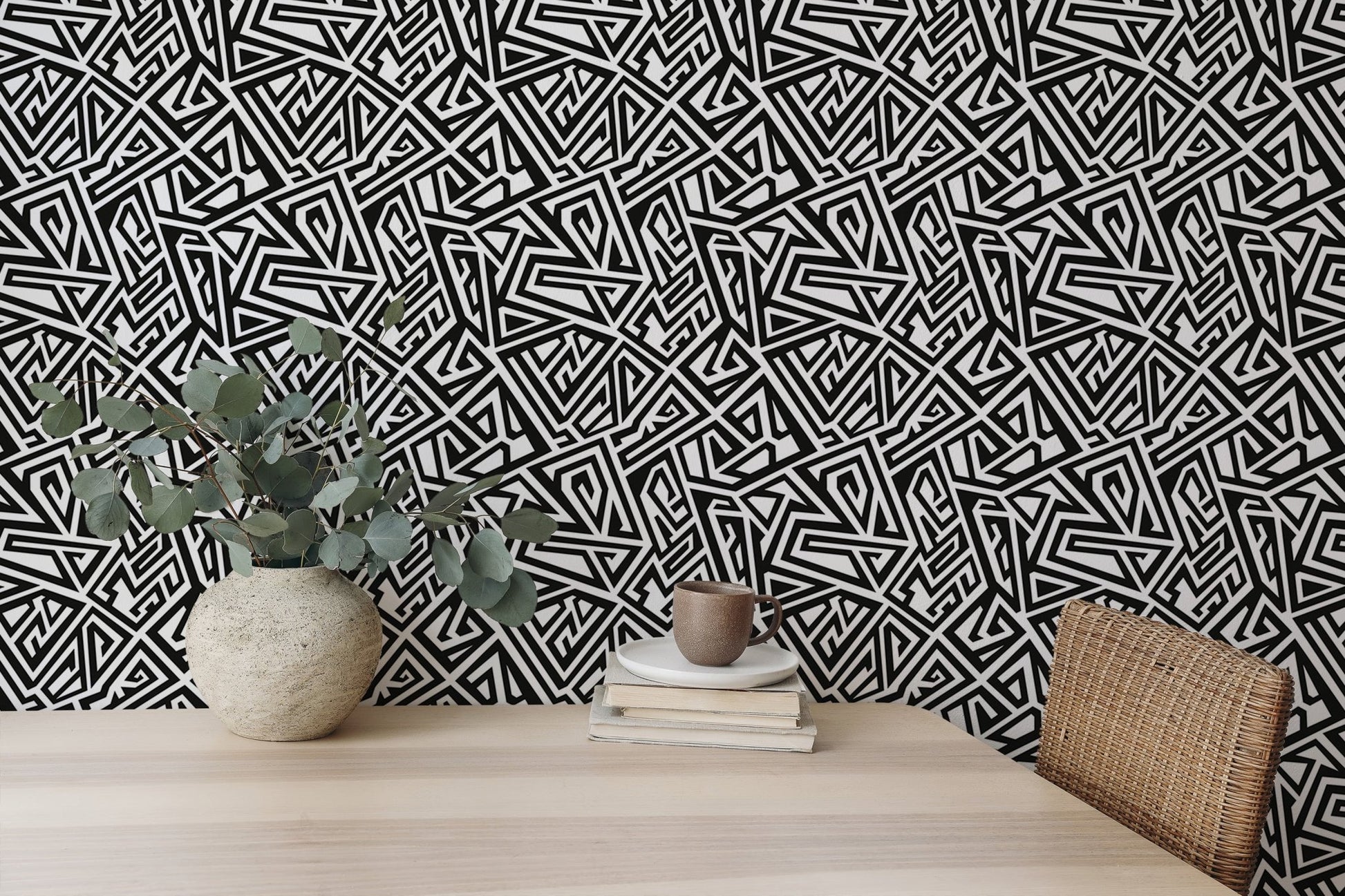 Home desk set against a monochrome geometric wallpaper backdrop.