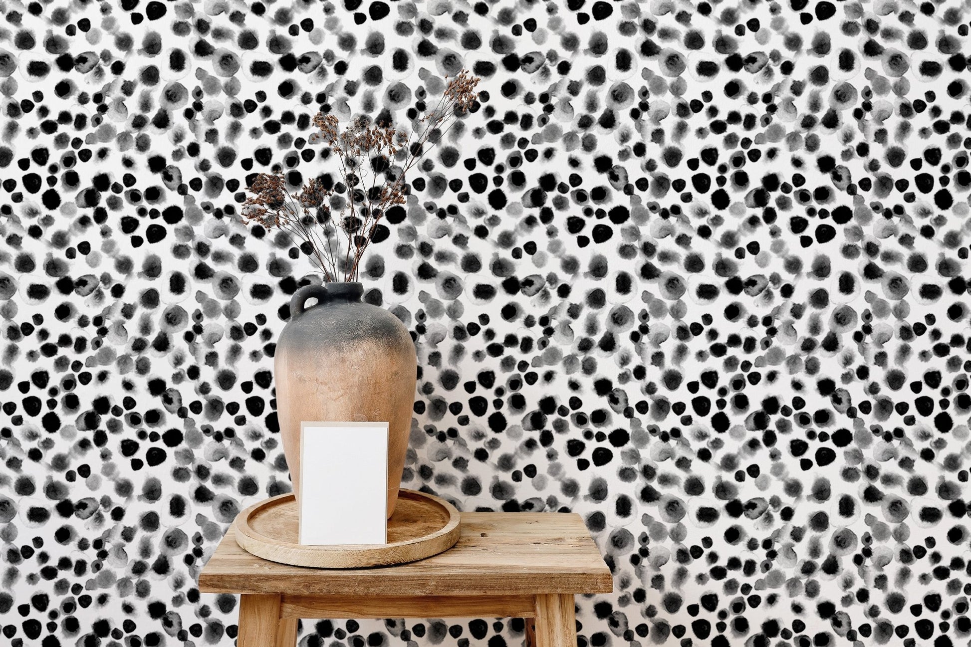 Monochrome abstract scattered wallpaper in a bright home space.