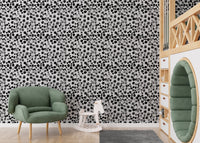 Geometric watercolor wallpaper used in a kids play area with a green chair.